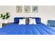Comfortable bedroom featuring a king-size bed with blue comforter and decorative pillows at 1138 E Liberty Shores Dr, Gilbert, AZ 85234