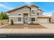 Charming two-story home featuring a well-manicured front yard, gray exterior, and a welcoming entrance with a lovely wreath at 1138 E Liberty Shores Dr, Gilbert, AZ 85234