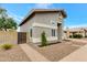 Side view of the home with pavers, stone landscaping and a wooden gate at 1138 E Liberty Shores Dr, Gilbert, AZ 85234