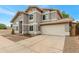 View of the home showing the garage and side of the house with well maintained rock landscaping at 1138 E Liberty Shores Dr, Gilbert, AZ 85234