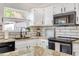 Charming kitchen with granite counters, white cabinets, updated appliances, and natural light at 1138 E Liberty Shores Dr, Gilbert, AZ 85234