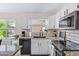 Bright kitchen with granite counters, white cabinets, updated appliances, and natural light streaming in at 1138 E Liberty Shores Dr, Gilbert, AZ 85234