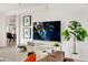 Modern living room area with wall art, TV, decor, and open to dining area in the background at 1138 E Liberty Shores Dr, Gilbert, AZ 85234