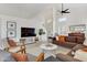 Spacious living room with tall ceilings, featuring comfortable seating, a modern TV setup, and a bright, airy ambiance at 1138 E Liberty Shores Dr, Gilbert, AZ 85234