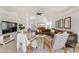 Bright living room with high ceilings, light tile floors, modern decor, a piano, and large windows at 1138 E Liberty Shores Dr, Gilbert, AZ 85234