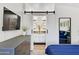 Bright main bedroom featuring a dark wood dresser and barn door leading to the Primary bath at 1138 E Liberty Shores Dr, Gilbert, AZ 85234