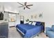 Comfortable main bedroom with a blue bed, barn door to the bathroom, and ample natural light at 1138 E Liberty Shores Dr, Gilbert, AZ 85234