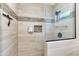 Close-up of tiled shower featuring a showerhead, glass door, and built-in soap and shampoo dispensers at 1138 E Liberty Shores Dr, Gilbert, AZ 85234