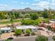 Aerial view of property with lush green surroundings and scenic mountain views in the background at 14401 N Coral Gables Dr, Phoenix, AZ 85023