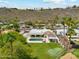 Sprawling backyard with pool, putting green, and mature trees offering privacy and mountain views at 14401 N Coral Gables Dr, Phoenix, AZ 85023