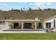 Inviting backyard featuring a sparkling pool, covered patio with ample seating, and mountain views at 14401 N Coral Gables Dr, Phoenix, AZ 85023