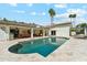 Beautiful backyard with a sparkling pool, travertine tile, covered patio, and outdoor dining area at 14401 N Coral Gables Dr, Phoenix, AZ 85023