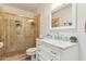 Bright bathroom featuring a white vanity and marble countertop, and a glass shower stall at 14401 N Coral Gables Dr, Phoenix, AZ 85023