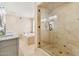 Elegant bathroom with marble finishes, a glass shower and a soaking tub at 14401 N Coral Gables Dr, Phoenix, AZ 85023