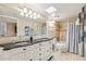 Bathroom featuring dual sinks with a black countertop and shower-tub combination at 14401 N Coral Gables Dr, Phoenix, AZ 85023