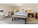 Cozy bedroom with neutral decor and a custom upholstered bench at 14401 N Coral Gables Dr, Phoenix, AZ 85023