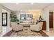 Cozy living room with neutral tones, area rug, comfortable seating, and views of the front yard at 14401 N Coral Gables Dr, Phoenix, AZ 85023