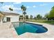 Refreshing pool with travertine tile surround, ladder entry and view of backyard landscaping at 14401 N Coral Gables Dr, Phoenix, AZ 85023