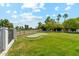 Backyard putting green surrounded by lush lawn and mature landscaping, perfect for recreation at 14401 N Coral Gables Dr, Phoenix, AZ 85023