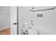 Bathroom features white tiles, a toilet, and bathtub with showerhead at 1748 E Cortez Dr, Gilbert, AZ 85234