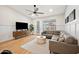 Bright living room features hardwood floors, comfortable sofa, ceiling fan, and access to outdoor patio at 1748 E Cortez Dr, Gilbert, AZ 85234