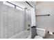 Well-lit bathroom featuring a shower-over-tub, white marble tiling, and modern fixtures for a clean and refreshing experience at 18642 N 13Th Ave, Phoenix, AZ 85027