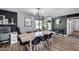 Contemporary dining area featuring a modern light fixture, large table, and stylish decor at 18642 N 13Th Ave, Phoenix, AZ 85027