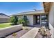 Inviting entrance with a neat garden, a sitting bench, and a clear pathway to the front door at 18642 N 13Th Ave, Phoenix, AZ 85027