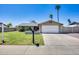 Charming single-story home featuring a well-manicured lawn, mature trees, and a two-car garage at 18642 N 13Th Ave, Phoenix, AZ 85027