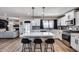 Bright kitchen with an island, modern appliances, grey backsplash, and seamless flow into an adjacent living area at 18642 N 13Th Ave, Phoenix, AZ 85027
