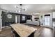 Well-lit living and dining room with modern lighting, and open access to the kitchen and living areas at 18642 N 13Th Ave, Phoenix, AZ 85027