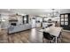 Open-concept living area showcasing modern decor, fireplace, dining and adjacent kitchen with island at 18642 N 13Th Ave, Phoenix, AZ 85027