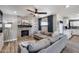 Comfortable living room featuring a stone fireplace, modern ceiling fan, and open layout at 18642 N 13Th Ave, Phoenix, AZ 85027