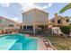 Well-maintained backyard featuring a sparkling pool, lush lawn, and covered patio for relaxing at 221 N Ironwood St, Gilbert, AZ 85234