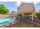 Charming backyard featuring a sparkling pool, lush lawn, and a covered patio for entertaining at 221 N Ironwood St, Gilbert, AZ 85234