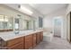 Bright primary bathroom with a soaking tub, dual sinks, and large mirror at 221 N Ironwood St, Gilbert, AZ 85234