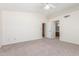 Spacious carpeted bedroom featuring a ceiling fan, closet, and ensuite bathroom access at 221 N Ironwood St, Gilbert, AZ 85234