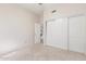 Light-filled bedroom with ample closet space and neutral carpeting at 221 N Ironwood St, Gilbert, AZ 85234