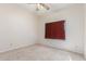 Cozy bedroom with neutral walls and a window with burgundy curtains at 221 N Ironwood St, Gilbert, AZ 85234