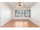 Empty dining room with wood floors, a ceiling fan, and natural light through the windows at 221 N Ironwood St, Gilbert, AZ 85234