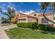 A glimpse of a one-story home with an attached garage and well kept lawn at 221 N Ironwood St, Gilbert, AZ 85234