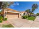 Attractive single-story home with a two-car garage and well-manicured lawn at 221 N Ironwood St, Gilbert, AZ 85234