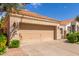 Close up of two car garage with low shrubbery along the front and gravel on the side at 221 N Ironwood St, Gilbert, AZ 85234