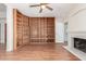 Bright living room with a fireplace, built-in bookshelves, and wood floors at 221 N Ironwood St, Gilbert, AZ 85234