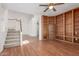 Open-concept living room with hardwood floors, built-in bookshelves, and staircase at 221 N Ironwood St, Gilbert, AZ 85234