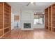 Bright living room with a fireplace, built-in bookshelves, and an adjacent laundry room at 221 N Ironwood St, Gilbert, AZ 85234