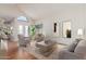 Bright living room featuring a large, arched window and neutral modern furniture at 221 N Ironwood St, Gilbert, AZ 85234