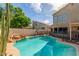 Beautiful backyard with a stunning pool, rock features, and mature landscaping, perfect for outdoor enjoyment at 221 N Ironwood St, Gilbert, AZ 85234