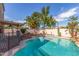 Lush backyard featuring a pristine pool, covered patio, mature trees and space for entertaining guests at 221 N Ironwood St, Gilbert, AZ 85234