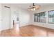 Bright room with hardwood floors, ceiling fan and natural light from a large window at 221 N Ironwood St, Gilbert, AZ 85234